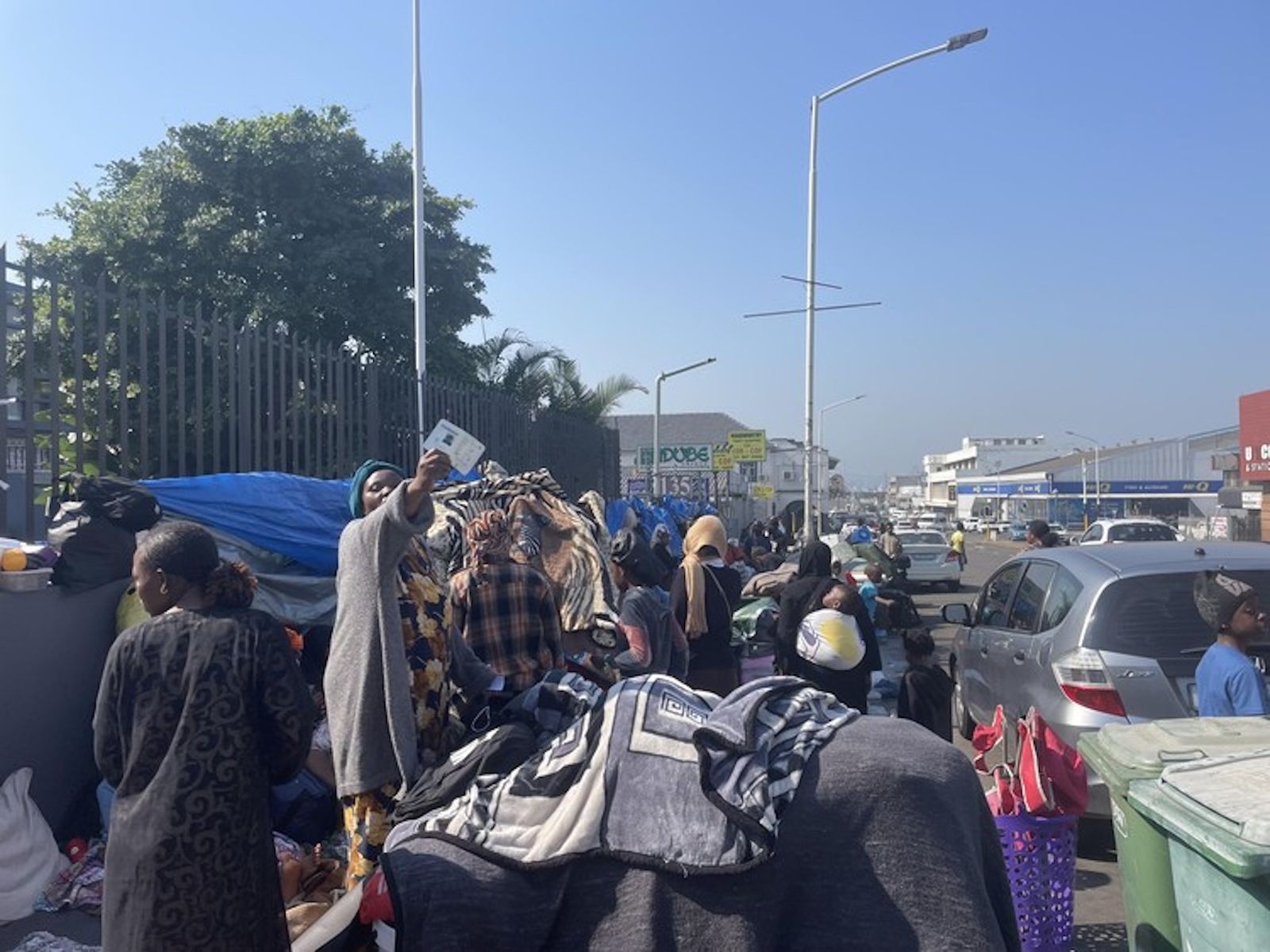 一名流离失所至德班Che Guevara Road的移民举起证件。原报道说，营地中几乎所有人均持有身份文件。 / Josep ...